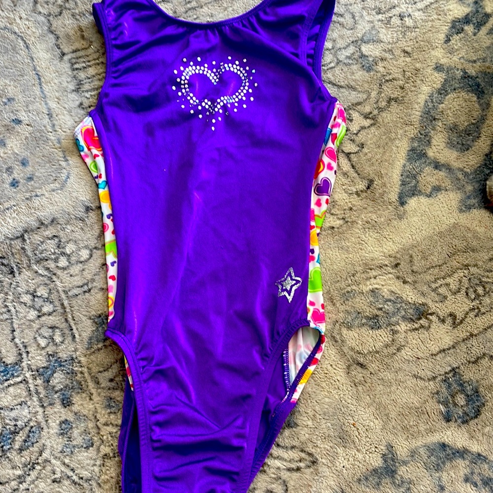 it is purple with silver heart printing and has hearts on the sides